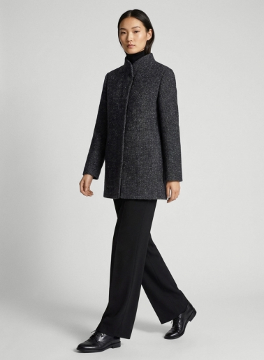 Short black coat with lurex micro pattern and high stand up collar