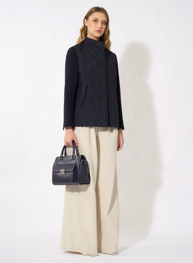 Dark blue quilted jacket with contrasting wool sleeves