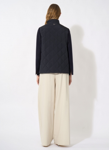 Dark blue quilted jacket with contrasting wool sleeves