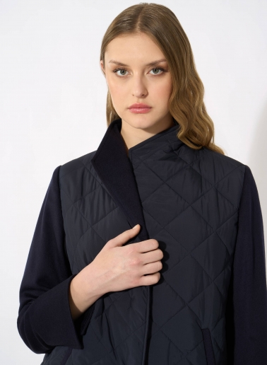 Dark blue quilted jacket with contrasting wool sleeves