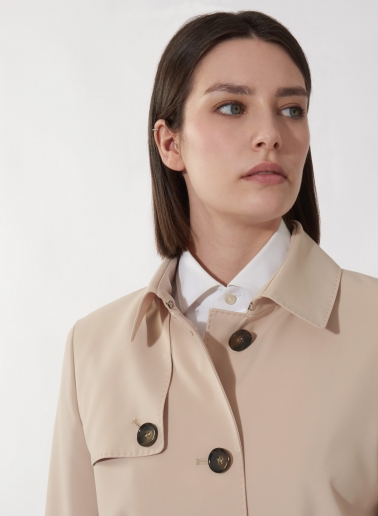 Single breasted beige trench coat in technical fabric with hand stitches